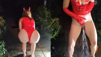 Devil horned lady takes a standing Halloween piss